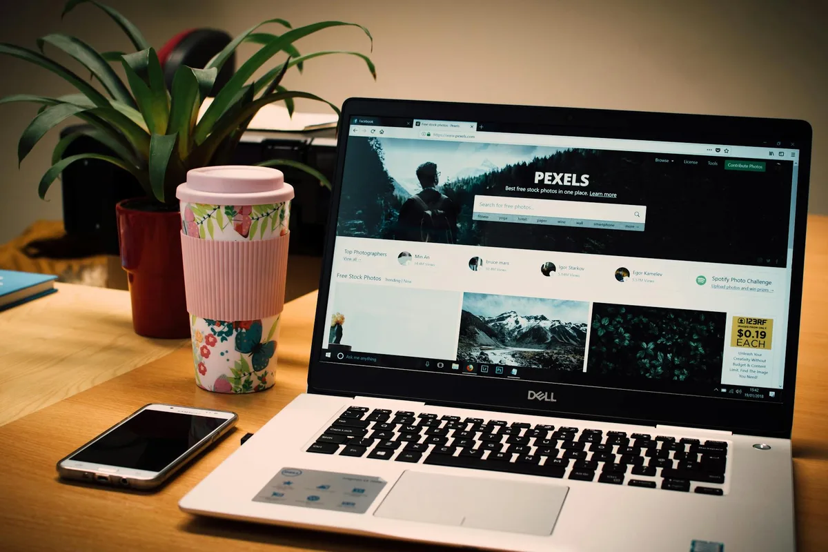 Website builder with drag-and-drop designer interface on a laptop