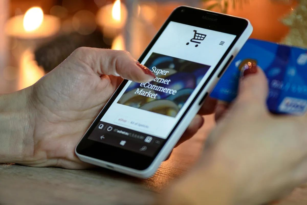 Mobile smartphone showing online shopping app in hand for UAE marketplace