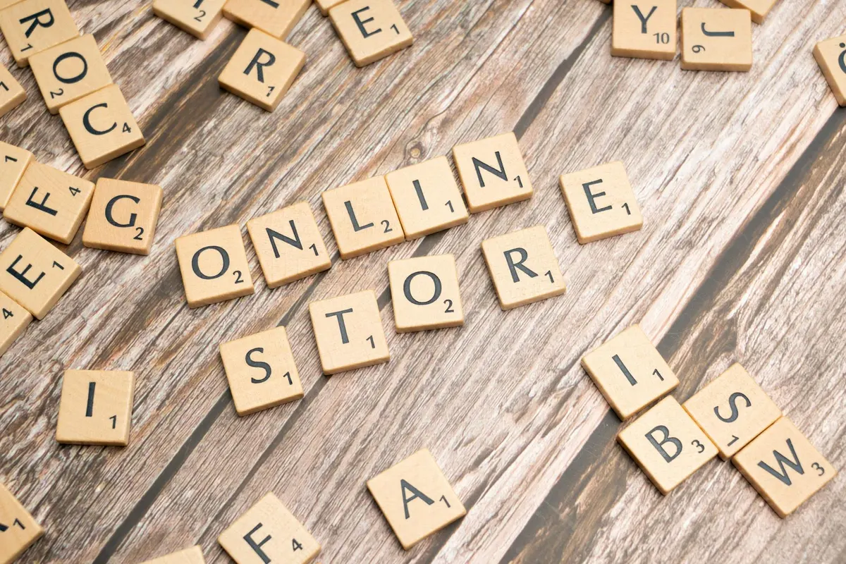 Malaysian seller comparing ecommerce platforms at a home workspace